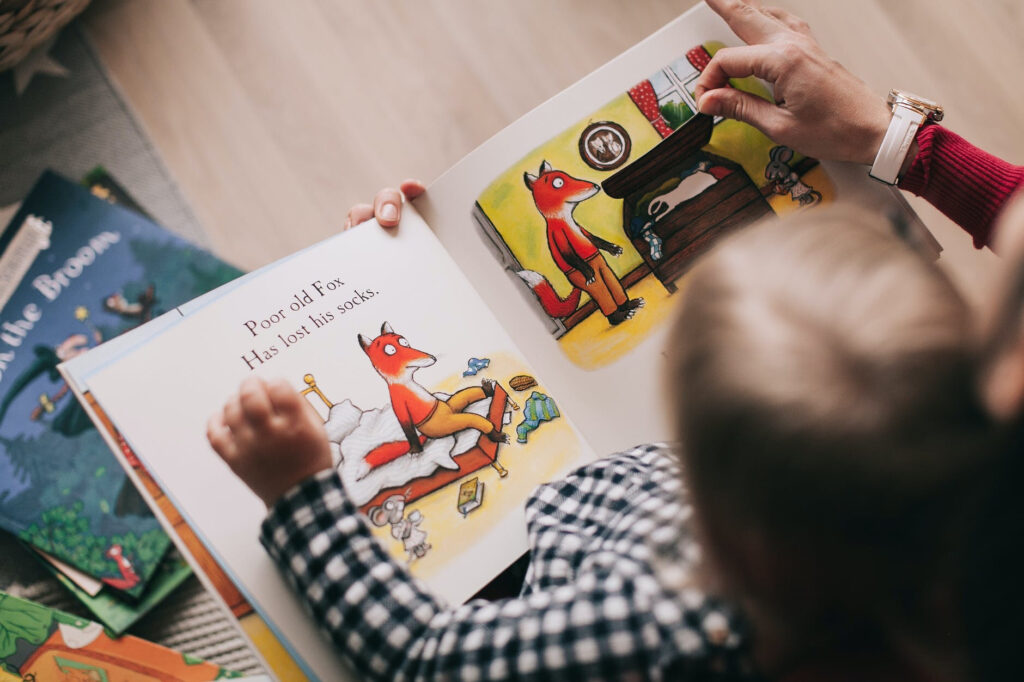 young child focused on reading picture book